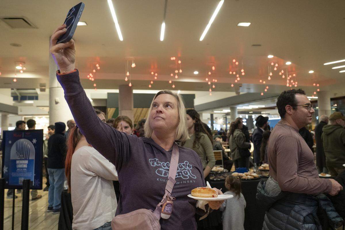 Members of the Roseville and Placer County Jewish community gather for a menorah lighting on the first night of Hanukkah at the Westfield Galleria in Roseville on Sunday.