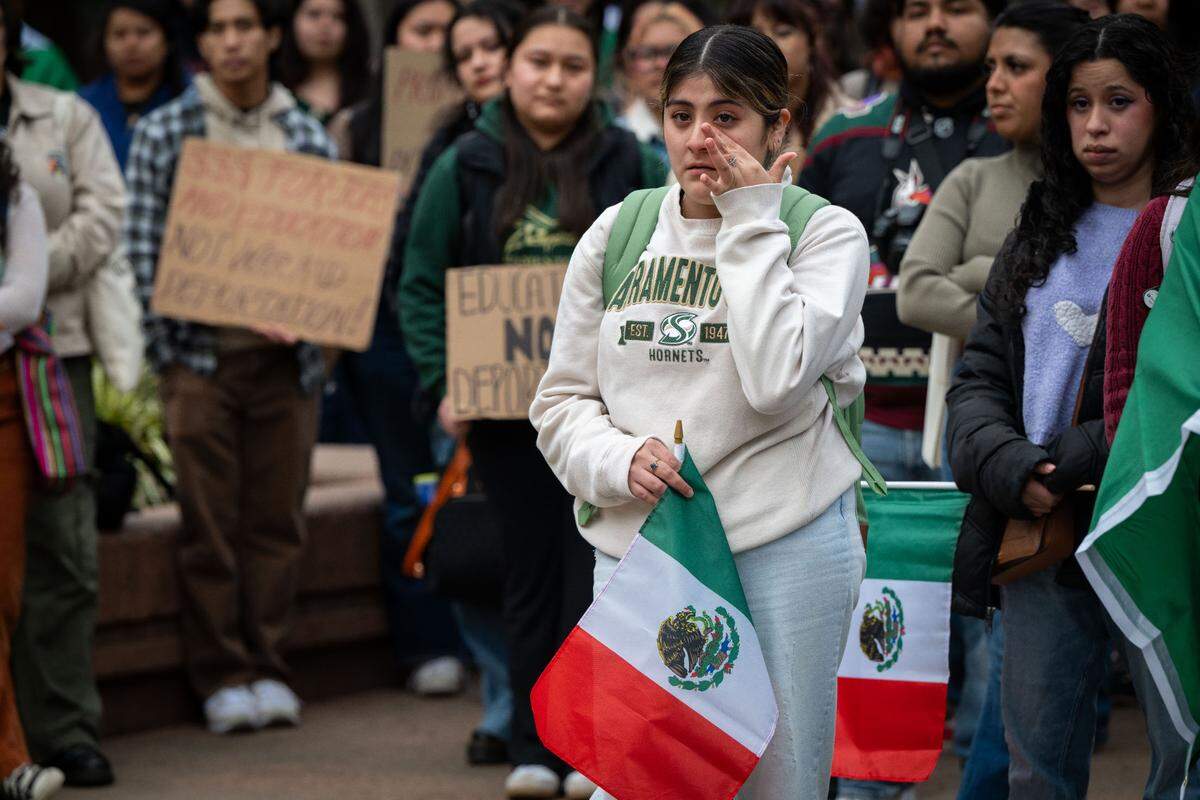 Michelle Blas wipes away tears as Sacramento State students protest Trump immigration policies and the school’s response to them Tuesday.