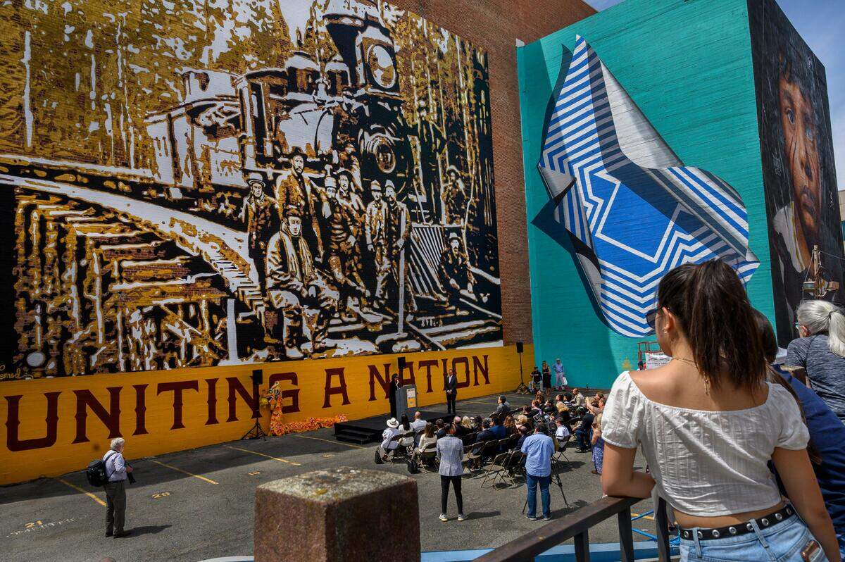 20. Muralist Maren Conrad of Sacramento unveils her mural to celebrate the 150th anniversary of Transcontinental Railroad and honor Chinese immigrants outside the historic Elks Tower building at the corner of 11th and J streets in downtown Sacramento on Monday, May 13, 2019.