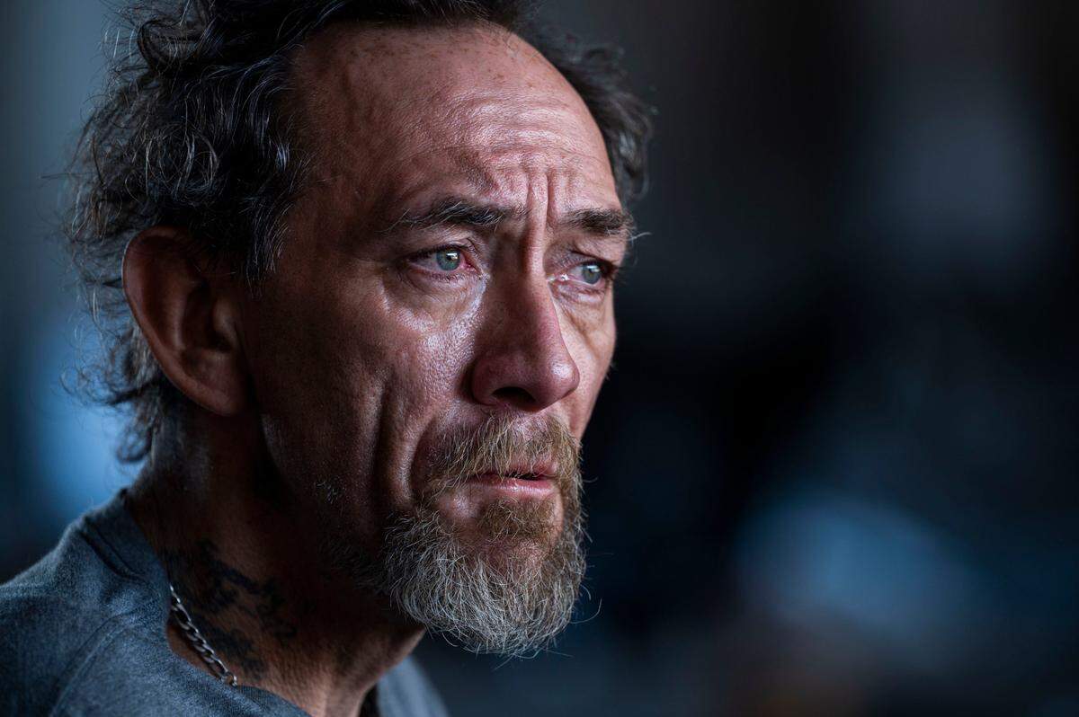 A homeless man who goes by the name of Spanky talks Wednesday to members of the Sacramento Community Response team on Broadway under Highway 99.