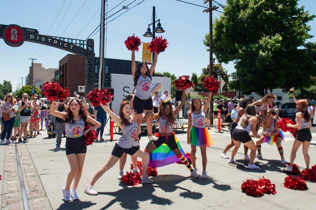The McClatchy High School dance team performs a stunt at R Street during the Sacramento Pride March and Parade on Sunday, June 11, 2023, in Sacramento.