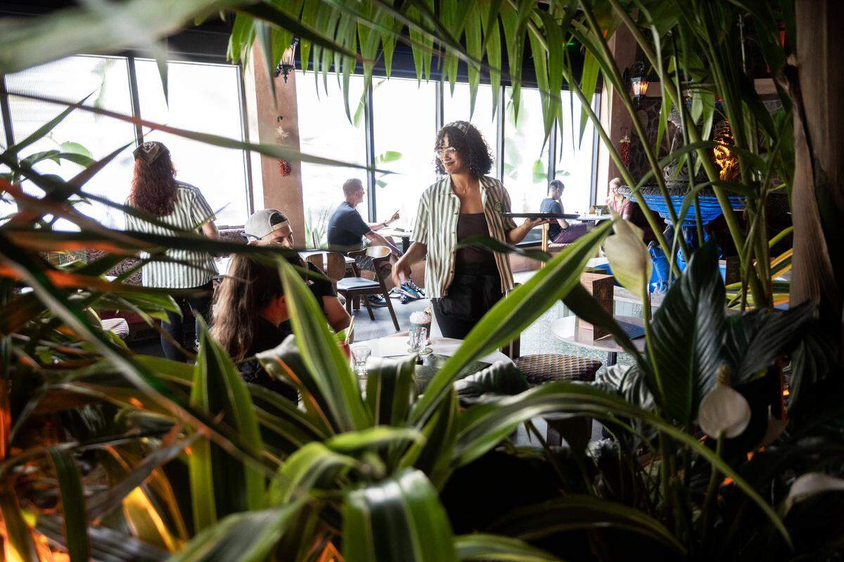 Khalia Petty, a bartender and server, checks in with patrons at Day Tripper in midtown Sacramento on Wednesday, May 27, 2026.