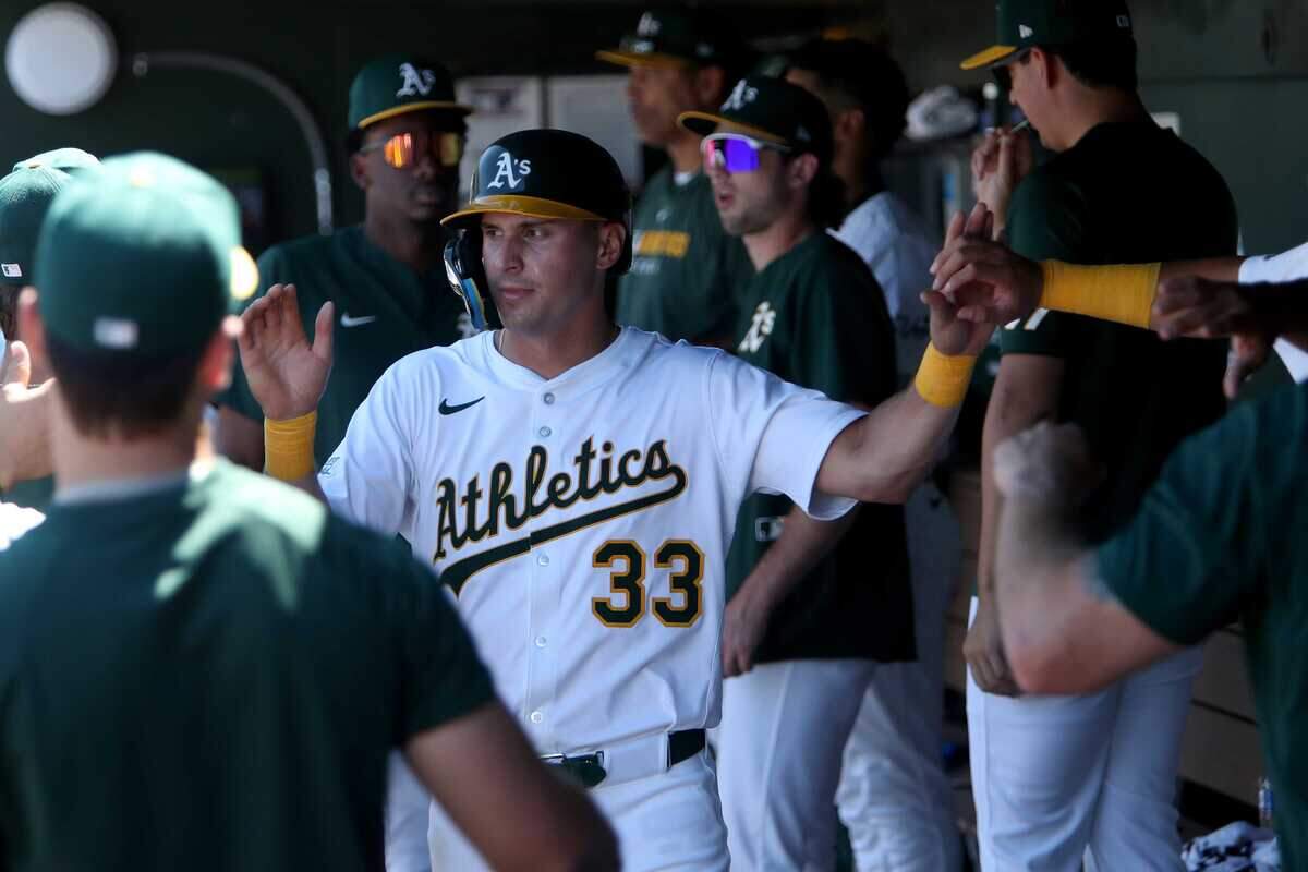 Athletics left fielder JJ Bleday (33) celebrates with teammates after scoring a run against the Arizona Diamondbacks during the seventh inning of Sunday's loss at Sutter Health Park.