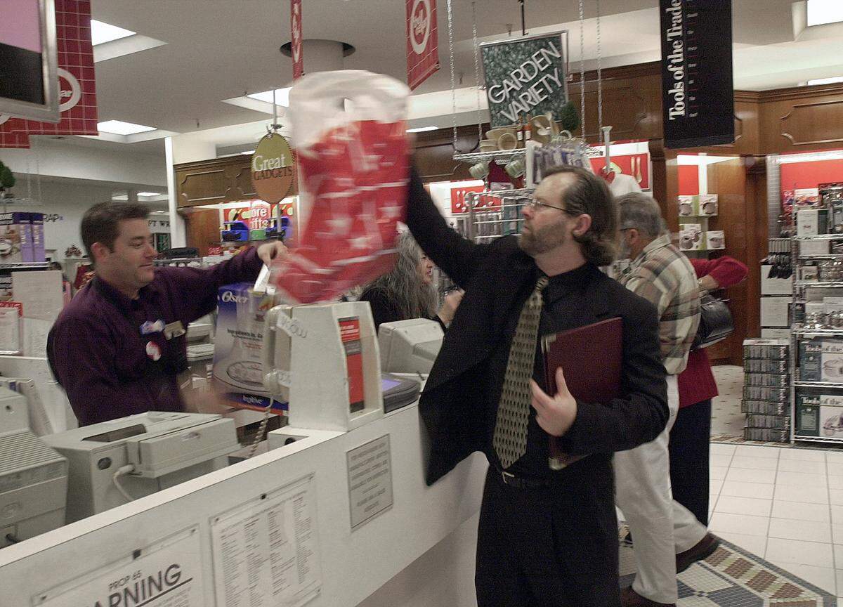 Dan Paterson completes some last minute shopping at the Downtown Plaza Macy’s on Tuesday, Dec. 18, 2001. Macy’s, one of the largest retailers in the area, is having many special sales including added markdown prices on items already at sale prices.