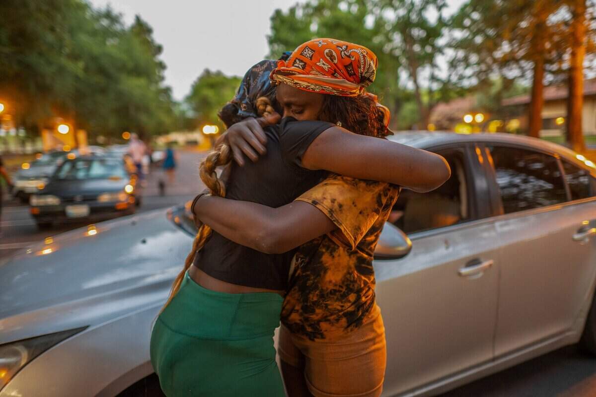 Antonita Brown, 33, right, is hugged by her daughter, Aliveeya, 13, near the car the family expects to sleep in after they were not allowed back into the Motel 6 shelter where they had been staying with Brown's husband on Wednesday, June 3, 2026, in Sacramento. Families were told to vacate the shelter on June 1 and were informed they could return at 3 p.m., but they were later denied reentry.