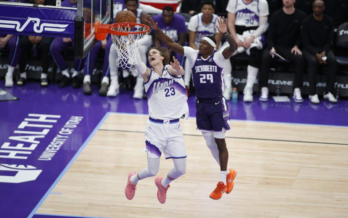 Lauri Markkanen (23) of the Utah Jazz scores against Daeqwon Plowden (29) of the Sacramento Kings during the first half of their game at the Delta Center on February 11, 2026 in Salt Lake City, Utah.
