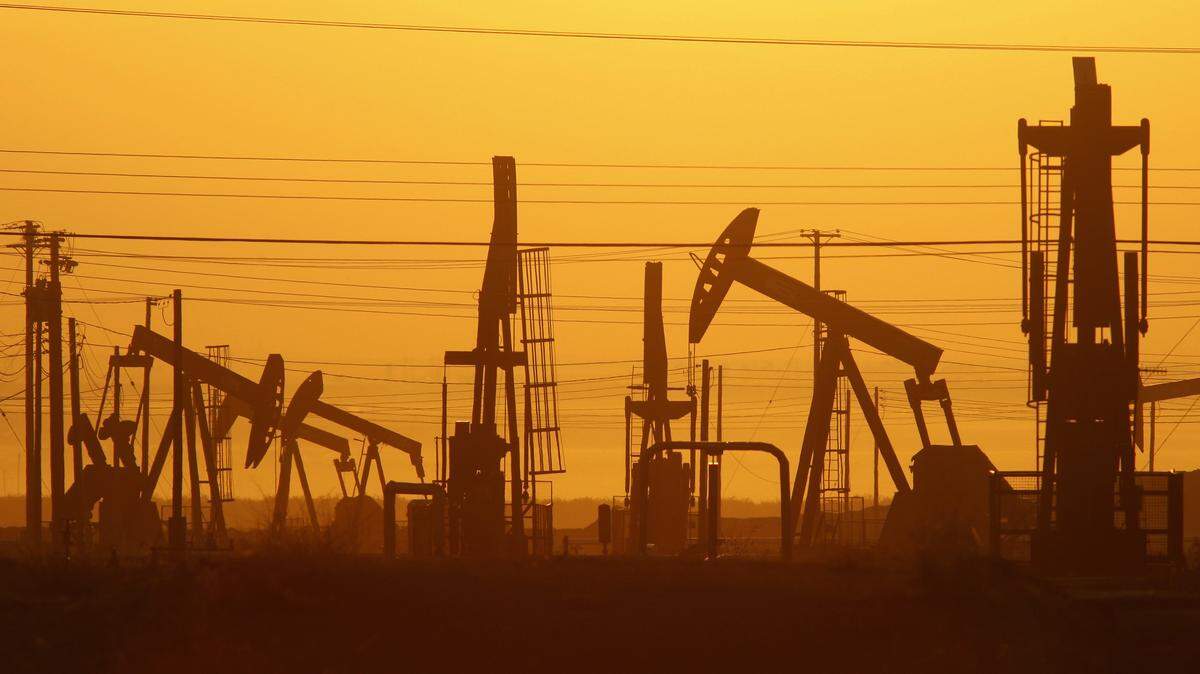Pump jacks are seen at dawn in an oil field over the Monterey Shale formation where gas and oil extraction using hydraulic fracturing, or fracking, is on the verge of a boom on March 24, 2014 near Lost Hills, California. New drilling and fracking allowances threaten California’s air, water and farms, putting low-income and vulnerable communities at heightened health risk.