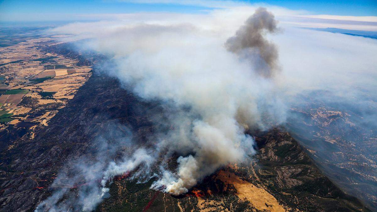 Northern California's County Fire sends huge plumes of smoke and ash into the air, as shown from an aerial view on Sunday, July 1, 2018. The fire continues to blaze through Yolo and Napa counties, at least 70,000 acres and 5 percent contained as of Tuesday morning, about 55 miles northwest of Sacramento between Highway 16 and Lake Berryessa.