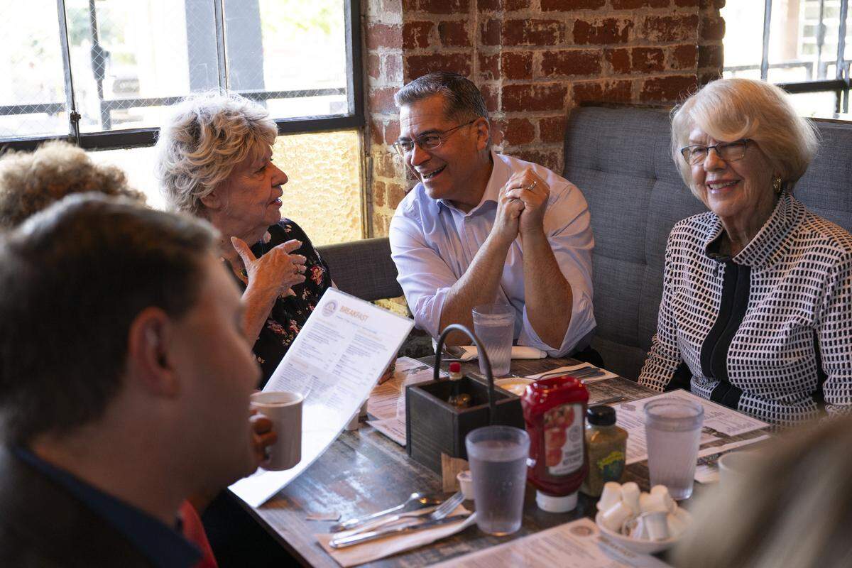 Xavier Becerra, center, a former state legislator and former attorney general of California, talks with former state legislator Paula Boland, left, and former state legislator Dede Alpert, right, during a reunion for the California Assembly class of 1990 at Fox & Goose in Sacramento on Wednesday.