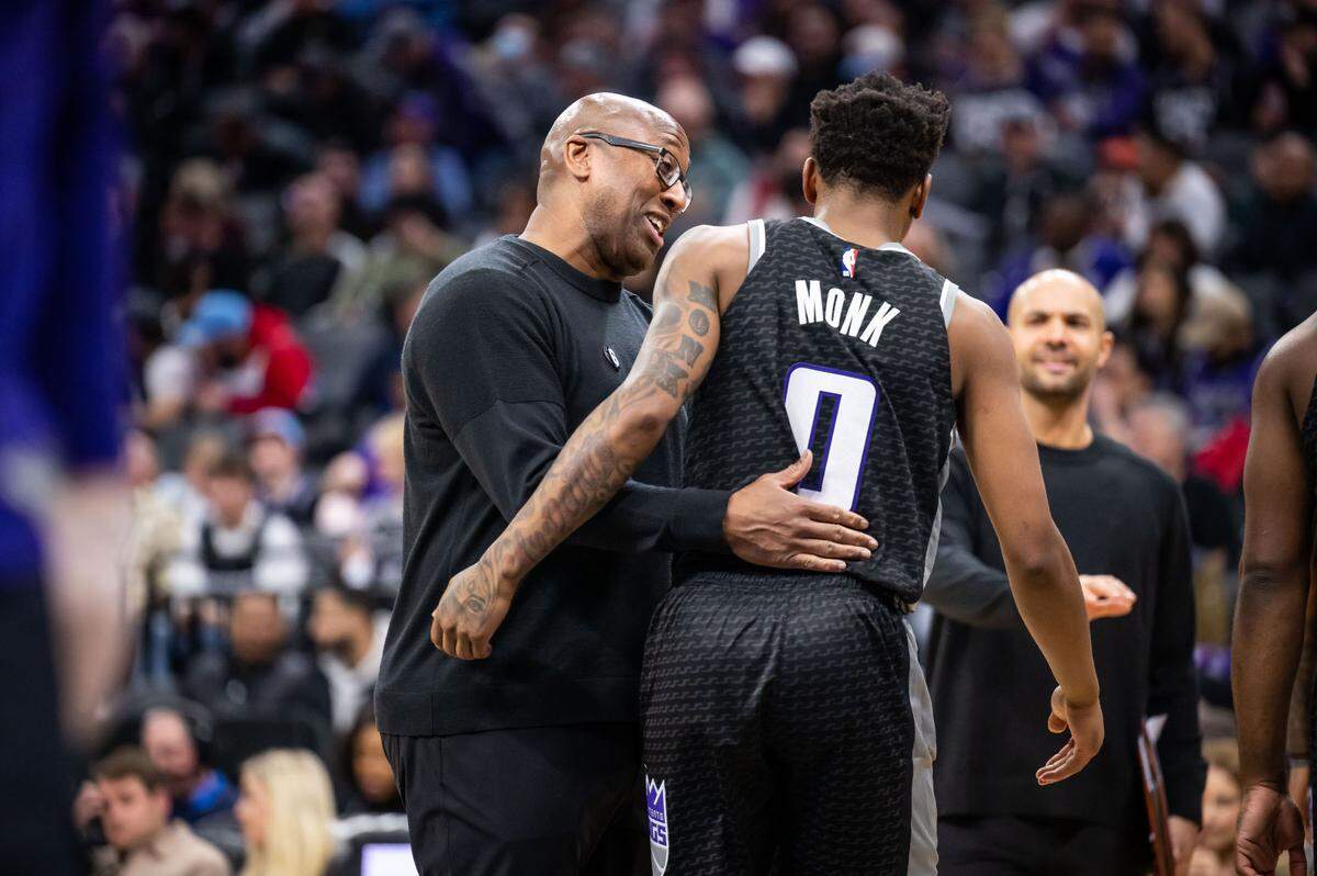 Sacramento Kings head coach Mike Brown greets guard Malik Monk (0) during a timeout after he took a fall on defense against the Houston Rockets during the third quarter of the NBA basketball game Wednesday, Jan. 11, 2023, at Golden 1 Center in Sacramento. The Kings beat the Rockets, 135-115.