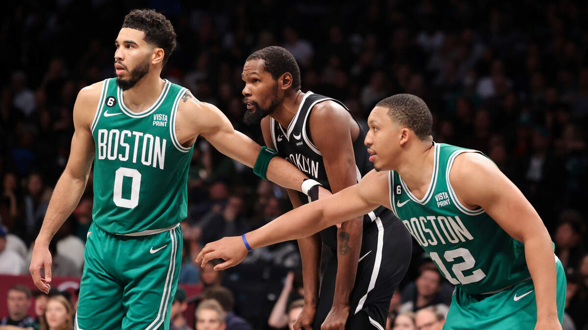 Boston Celtics forward Jayson Tatum (0) and Boston Celtics forward Grant Williams (12) shield Brooklyn Nets forward Kevin Durant during the second half of an NBA basketball game, Sunday, Dec. 4, 2022, in New York. (AP Photo/Jessie Alcheh)