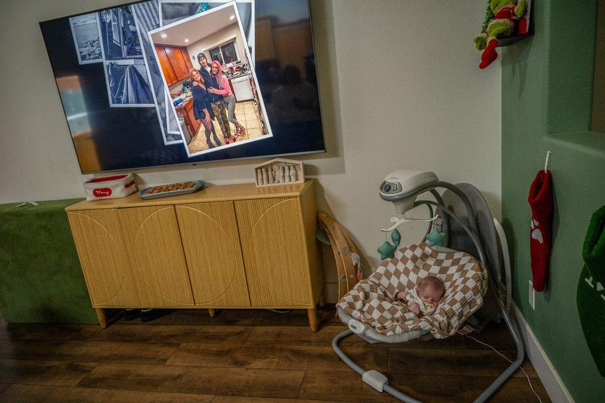 A photo of Michelle Glass, left, and Erika Pringle, right, hugging their late brother, Andrew James Mathew Pringle, is displayed on a screensaver as two-month-old Andrew James Glass  —named after his late uncle — naps on Nov. 20 in Rancho Cordova. His uncle was hit by a driver who ran a red light in Rosemont in 2023. Michelle said that if she has another baby and it is a boy, she would name him Mathew to honor her brother a second time.