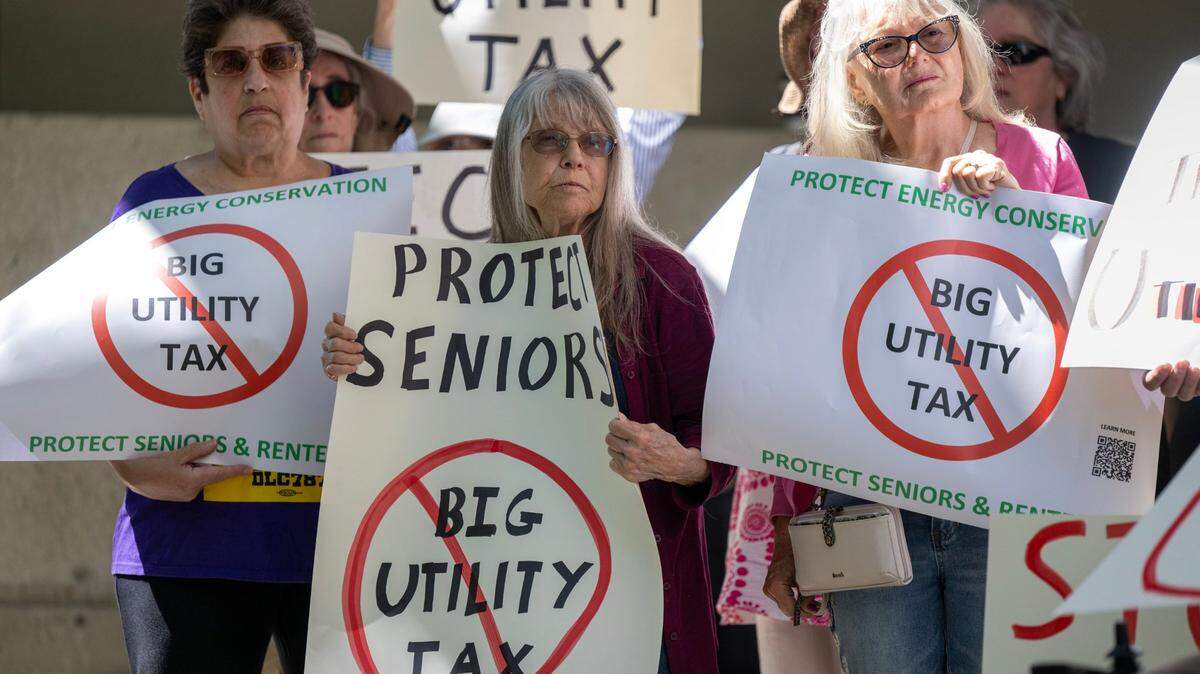 Francesca Wander, Karen Jacques and Mary Steinert join a coalition of renters, seniors, affordable housing advocates and environmentalists protesting outside the California Public Utilities Commission meeting at Warren Alquist State Energy Building in Sacramento on Thursday, May 9, 2024.