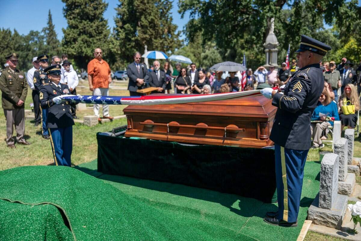 Soldiers fold the American flag over the casket of Cpl. Albert Estrada, who was killed and missing in action during the Korean War, in St. Joseph’s Cemetery in Woodland on Wednesday, June 18, 2025.
