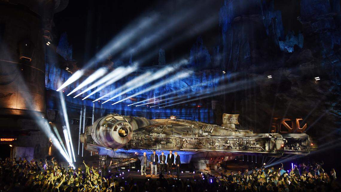 The Millennium Falcon starship is pictured onstage during a dedication ceremony for the new Star Wars: Galaxy’s Edge attraction at Disneyland Park on May 29 in Anaheim, Calif. From left, “Star Wars” film franchise creator George Lucas, cast members Billy Dee Williams and Mark Hamill, Walt Disney Co. Chairman and CEO Bob Iger and cast member Harrison Ford stand onstage.