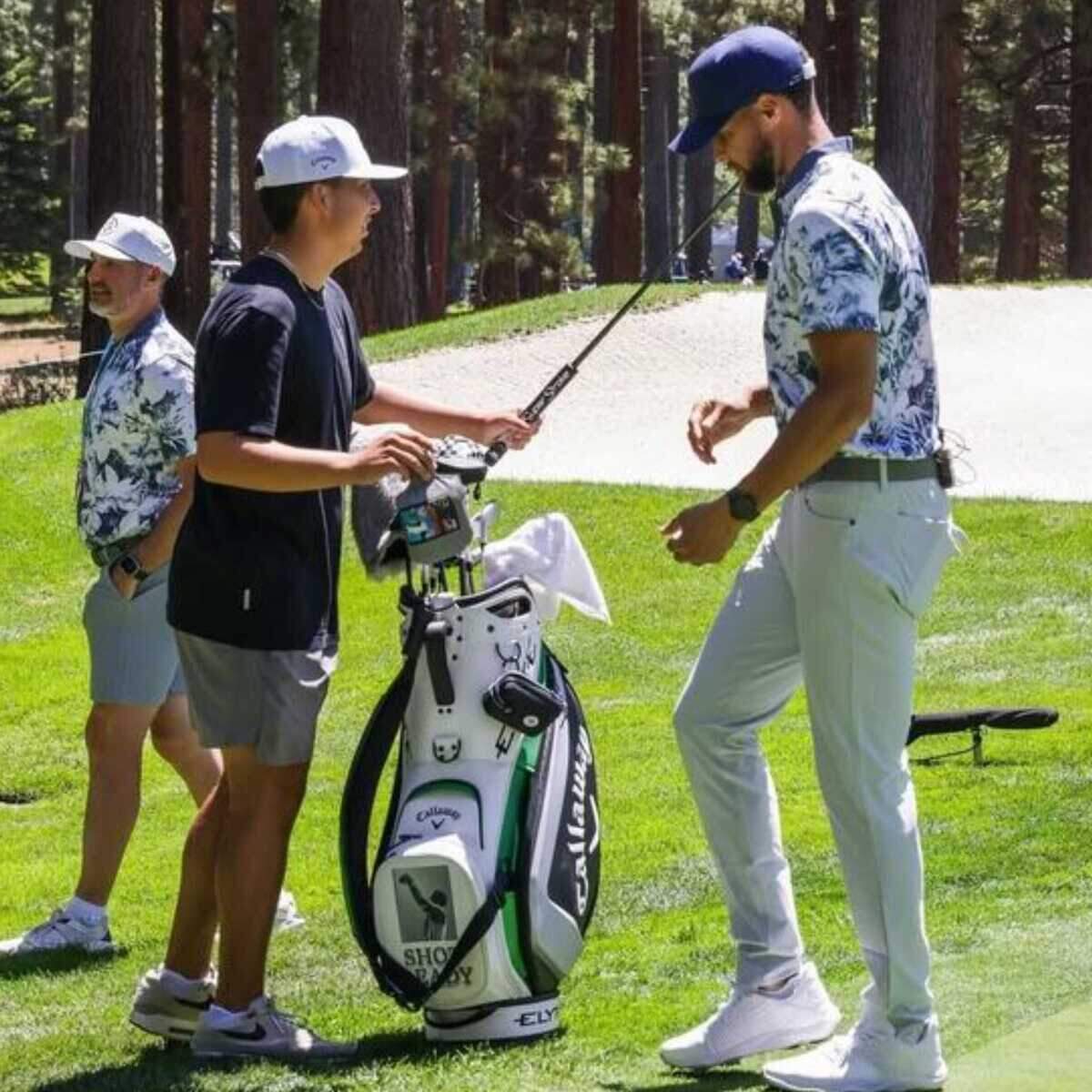 Tre Garza walks the green alongside Stephen Curry during the Underrated Golf Tour earlier this summer. Garza, a junior at Granite Bay High School, was handpicked to caddie for Curry for part of the tournament and said the experience was unforgettable.