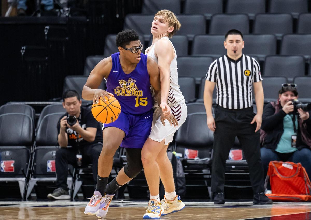 Sierra Chieftains forward Luke Brown (21), right, guards Lynwood Knights forward Syeon Jennings (15) as he goes up to score during the fourth quarter at the CIF Division V high school boys basketball state final game Friday, March 10, 2023, at Golden 1 Center in Sacramento. Lynwood beat Sierra for the state title, 89-58.