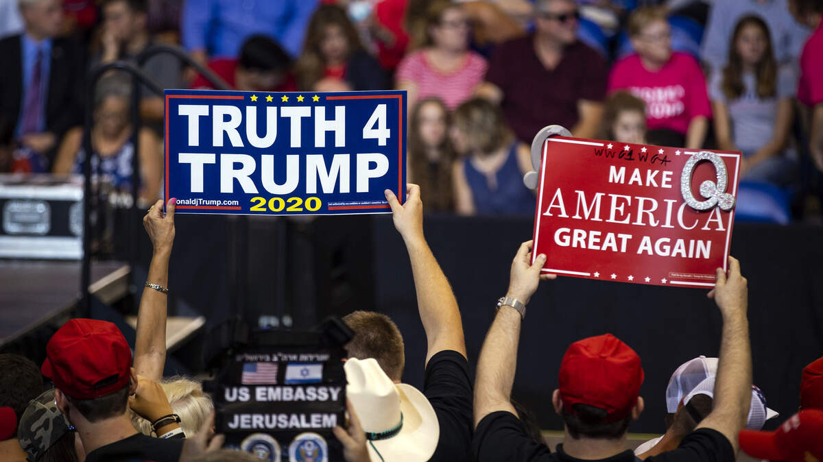 A supporter of President Donald Trump holds up a sign referencing QAnon, a fringe movement that discusses several loosely connected and vaguely defined  and baseless  conspiracy theories, during a rally Aug. 2 in Wilkes-Barre, Pa.