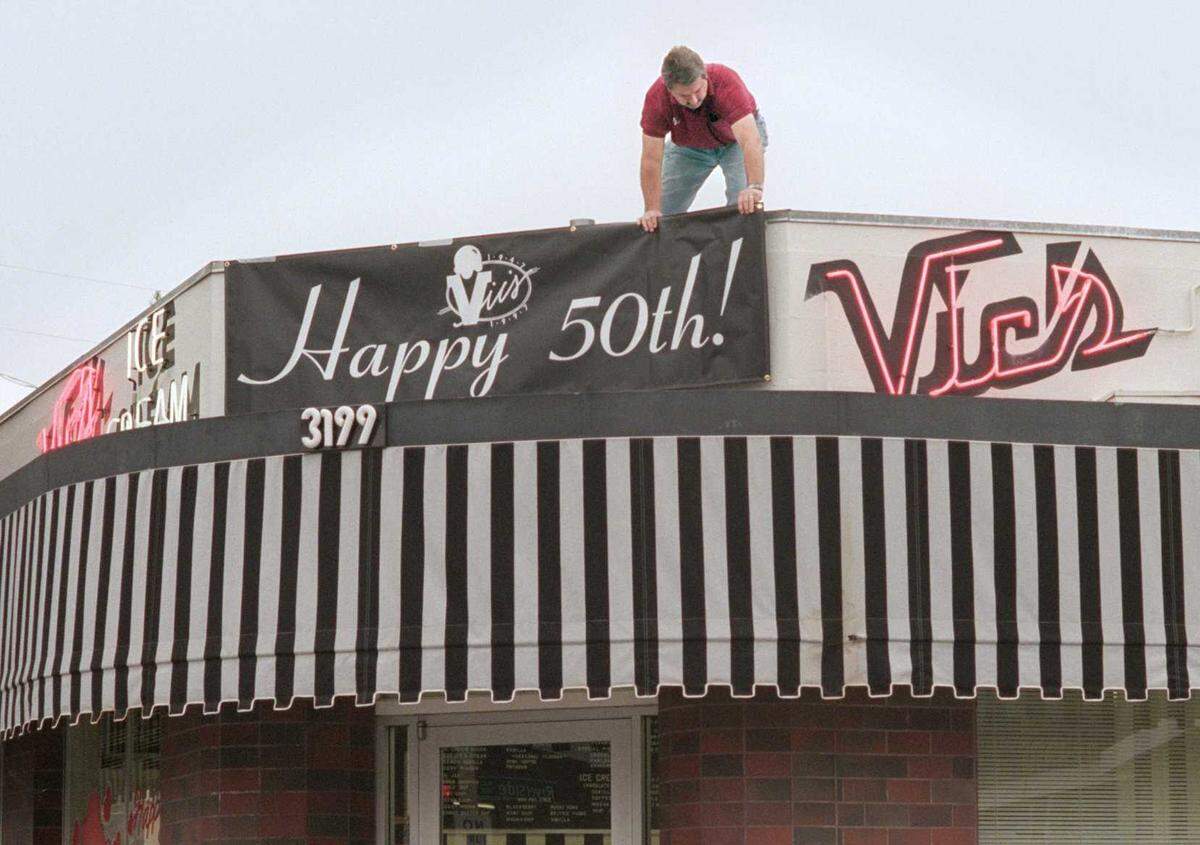 Vic’s Ice Cream owner Craig Rutledge puts up 50th Anniversary banner on the front of establishment at 3199 Riverside Blvd. Rutledge, who operated the ice cream parlor for 40 years, died Monday at the age of 73.