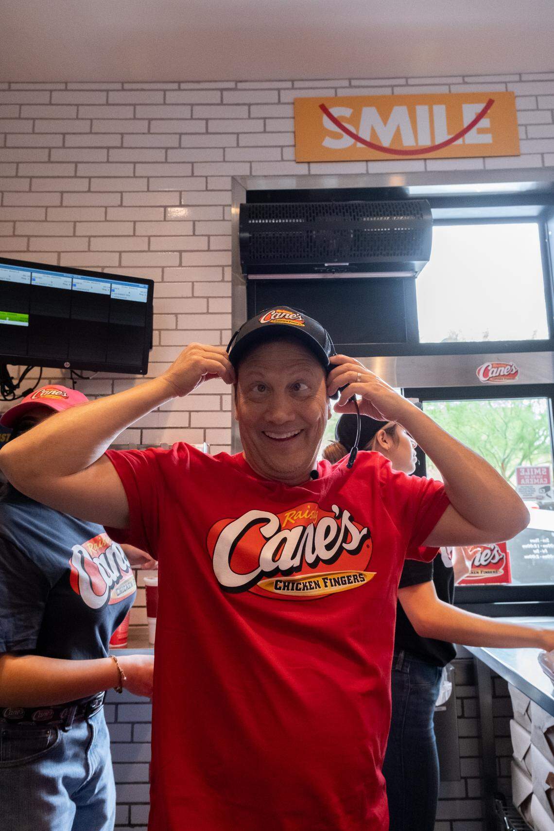 Rob Schneider works the drive-thru at Raising Cane’s in Phoenix, Arizona.