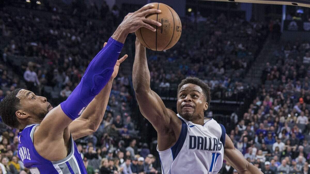 Kings guard Garrett Temple, left, fights for the ball with Dallas Mavericks guard Yogi Ferrell on Feb. 3 at Golden 1 Center. Ferrell agreed to a two-year deal with the Kings on Friday.
