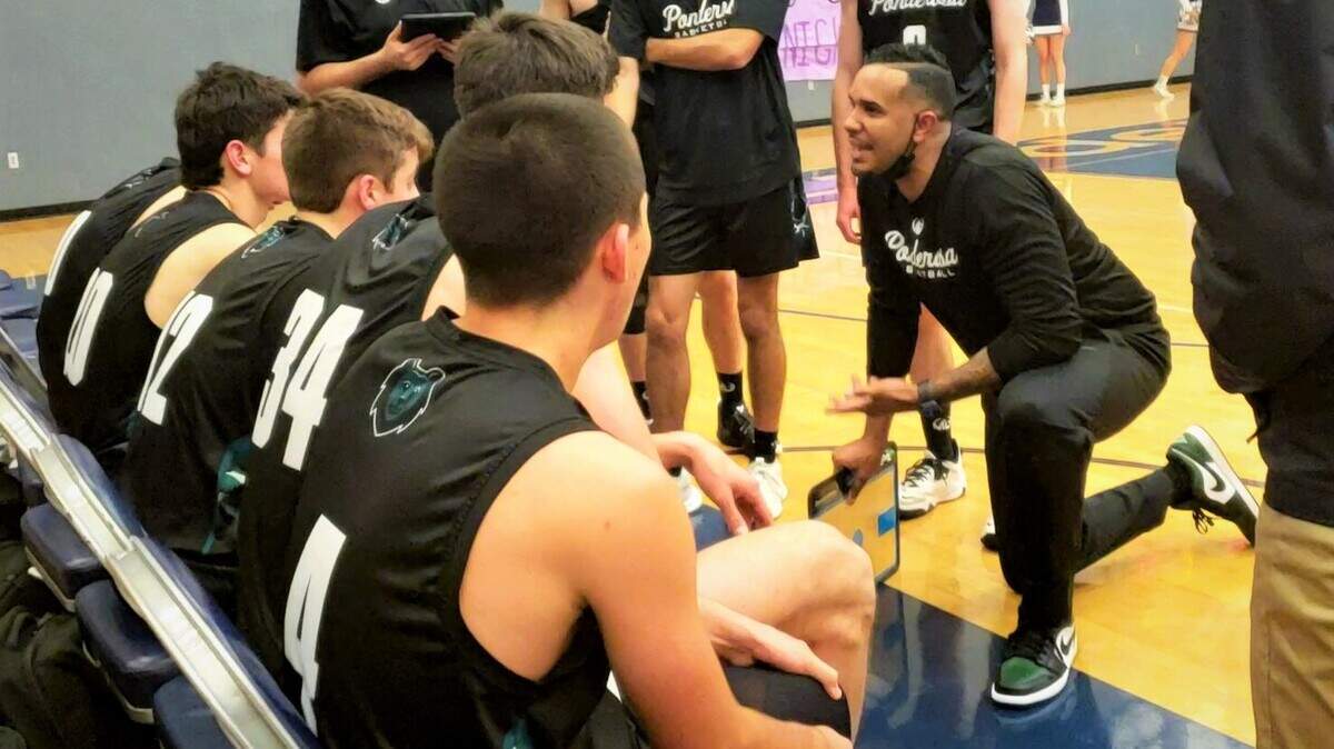 Ponderosa head coach Clark Woods encourages his team during a timeout in Wednesday night’s 71-46 win at Vista del Lago High School.