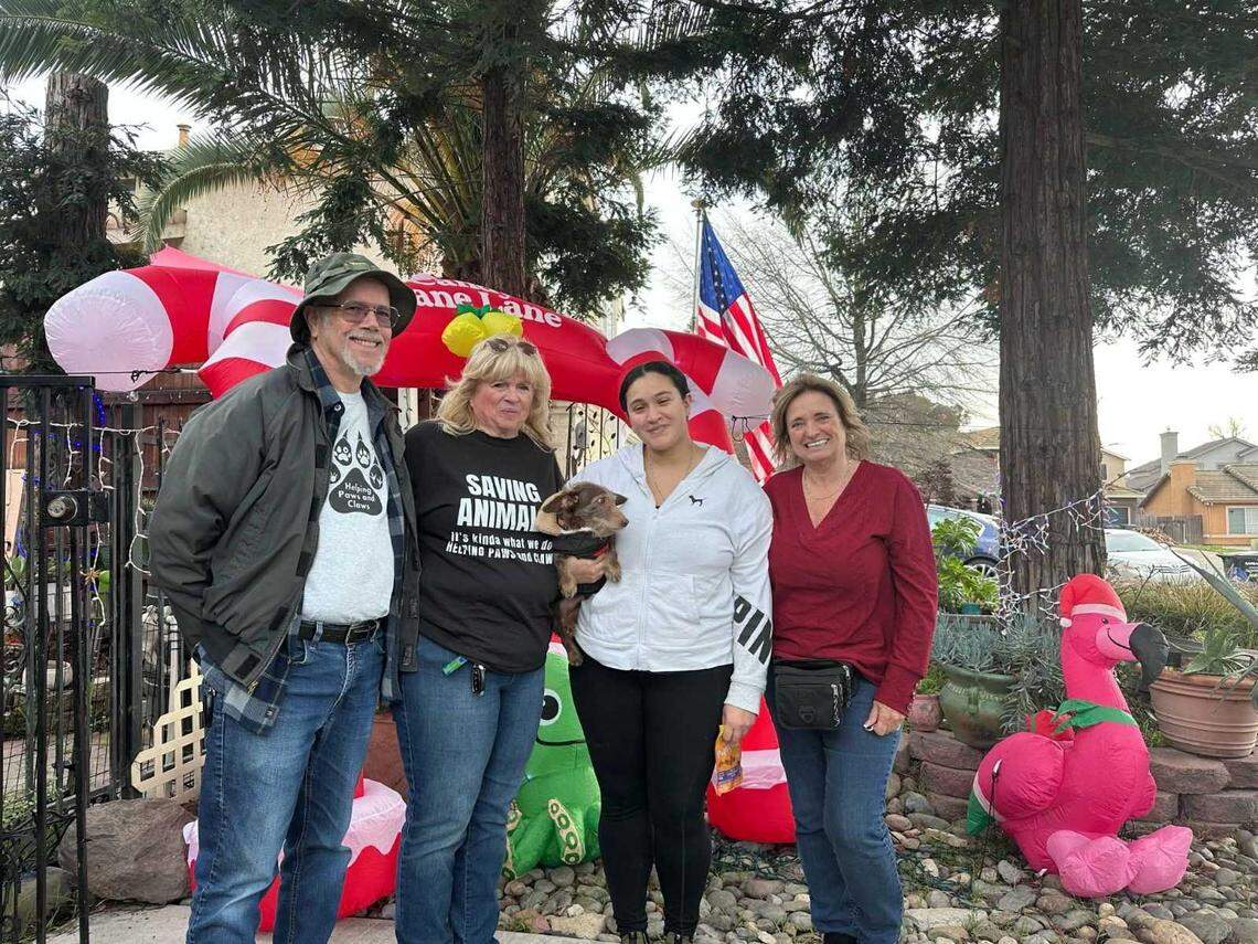 Patricia Orozco, second from right, holds Choco after reuniting with the dog nearly five years after he went missing. From left are Nic Thompson, Cindy Walden and Penny Scott, volunteers with Loomis-based Helping Paws and Claws, which helped coordinate Choco's return from Michigan.