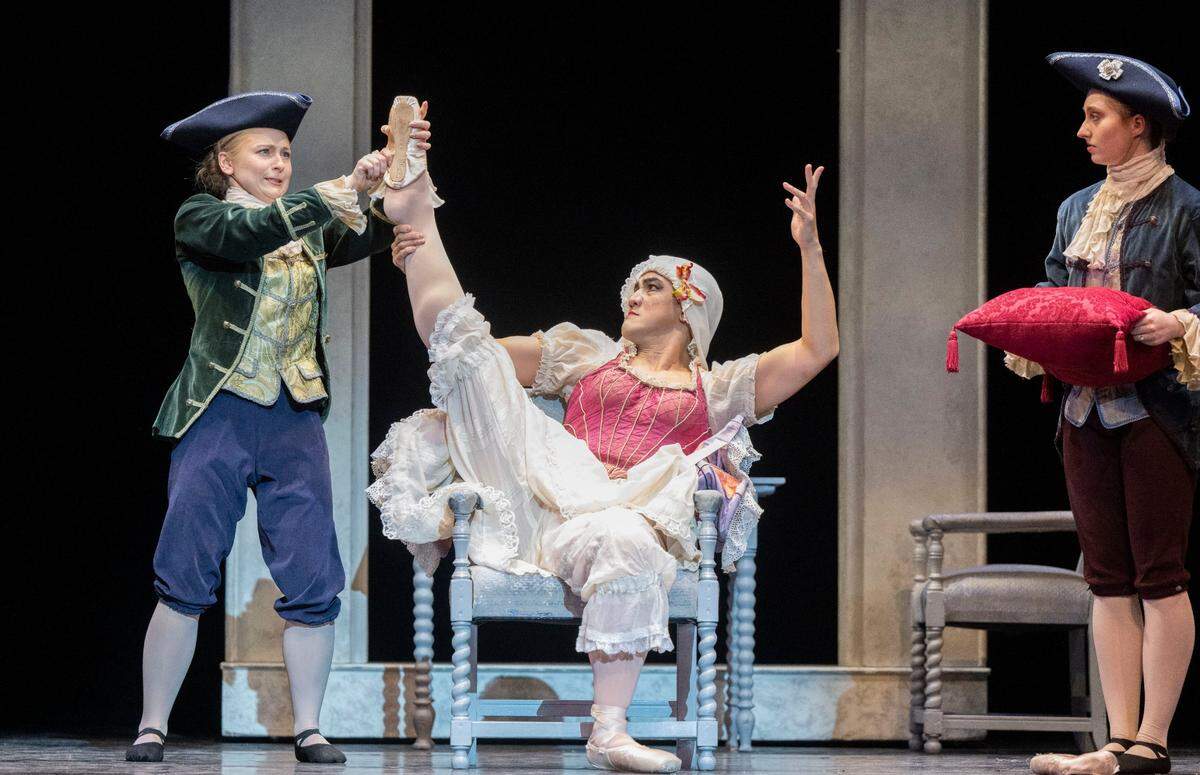 Eugene Obille, center, playing an evil step sister, tries to force the missing ballet slipper to fit during a Sacramento Ballet dress rehearsal of Cinderella on Thursday, Feb. 15, 2024.