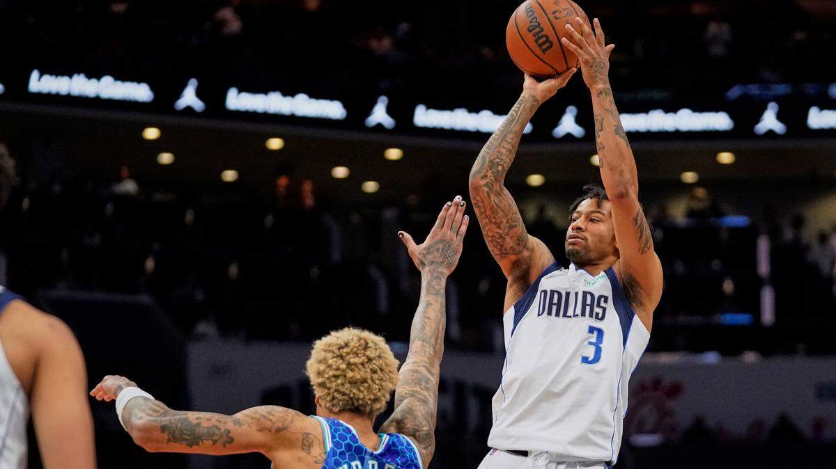 Dallas Mavericks guard Trey Burke (3) shoots over Charlotte Hornets guard Kelly Oubre Jr. during the second half of an NBA basketball game Saturday, March 19, 2022, in Charlotte, N.C. (AP Photo/Rusty Jones)