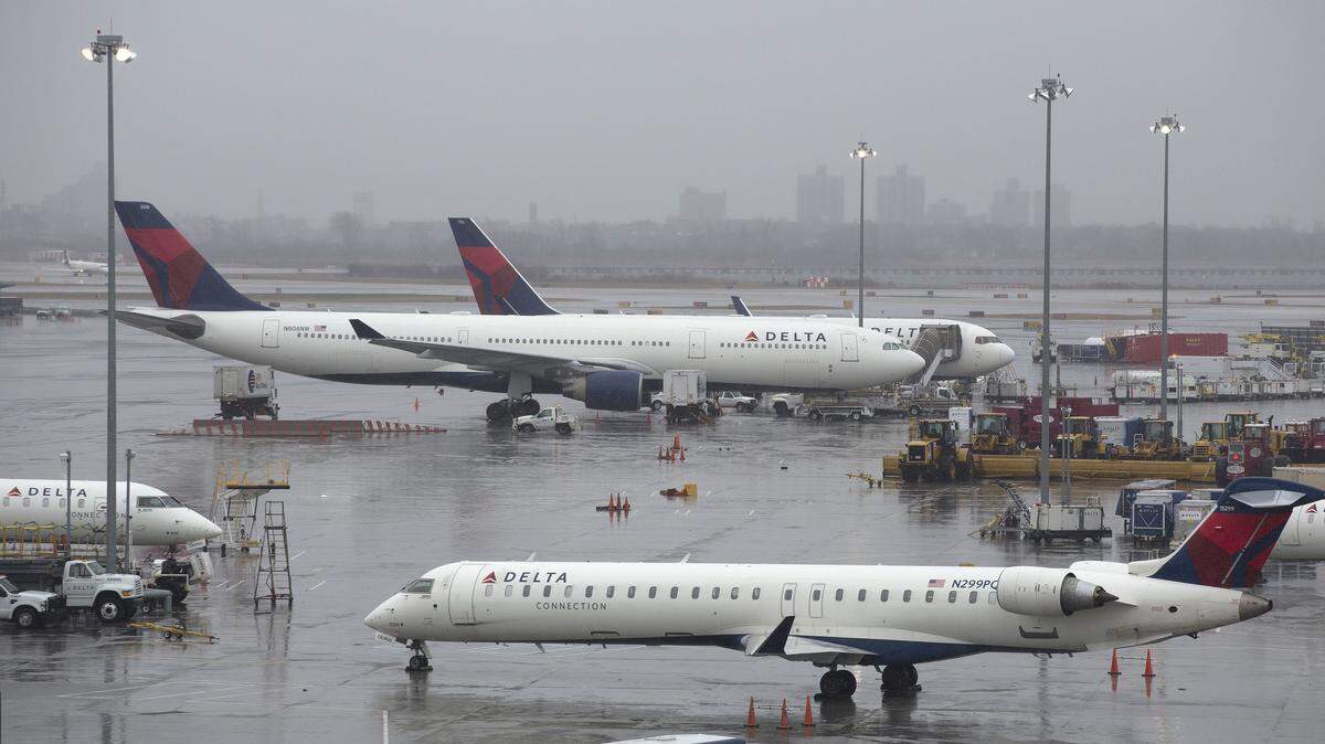 Delta airplanes are grounded, Friday, March 2, 2018, in New York. Airlines have canceled many flights out of New York as a severe storm arrives in the northeast.
