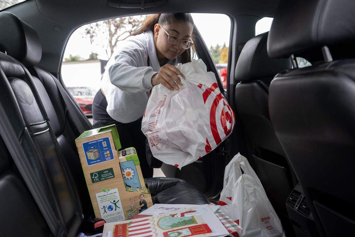 Jazmine Valencia, 29, loads her purchases at Target in Sacramento on Friday, Dec. 19, 2025.