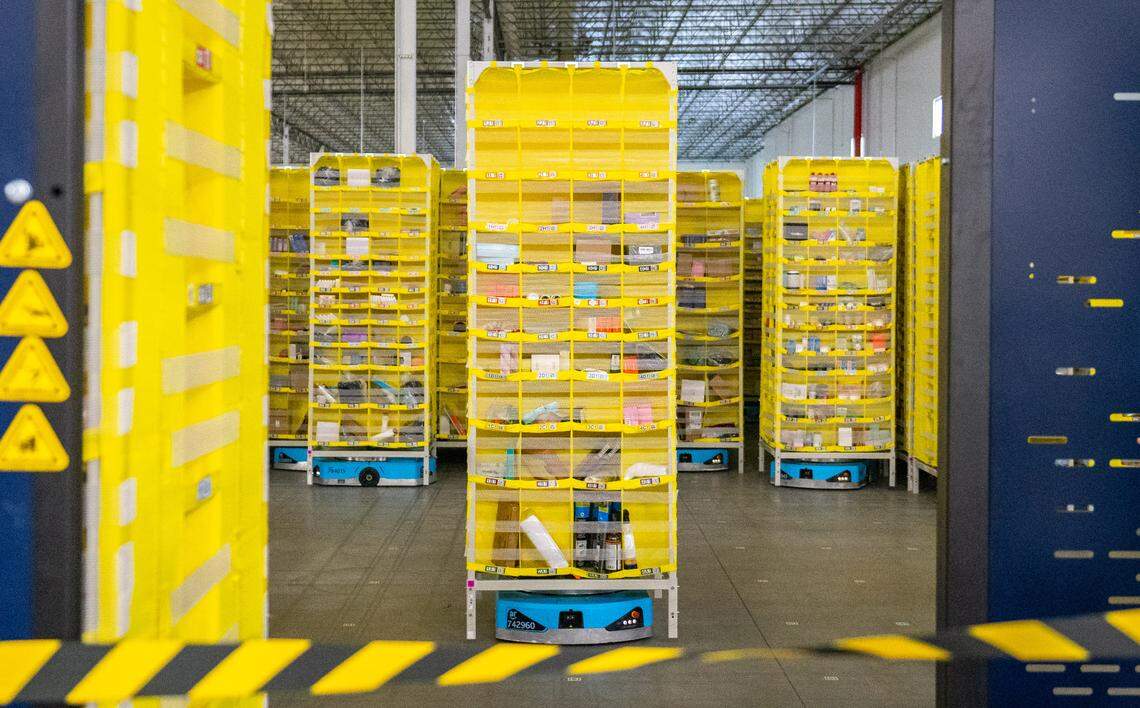 Floor robots at Amazon’s Sacramento same-day fulfillment center move 14-foot tall pods containing shelves holding hundreds of delivery items on Wednesday.