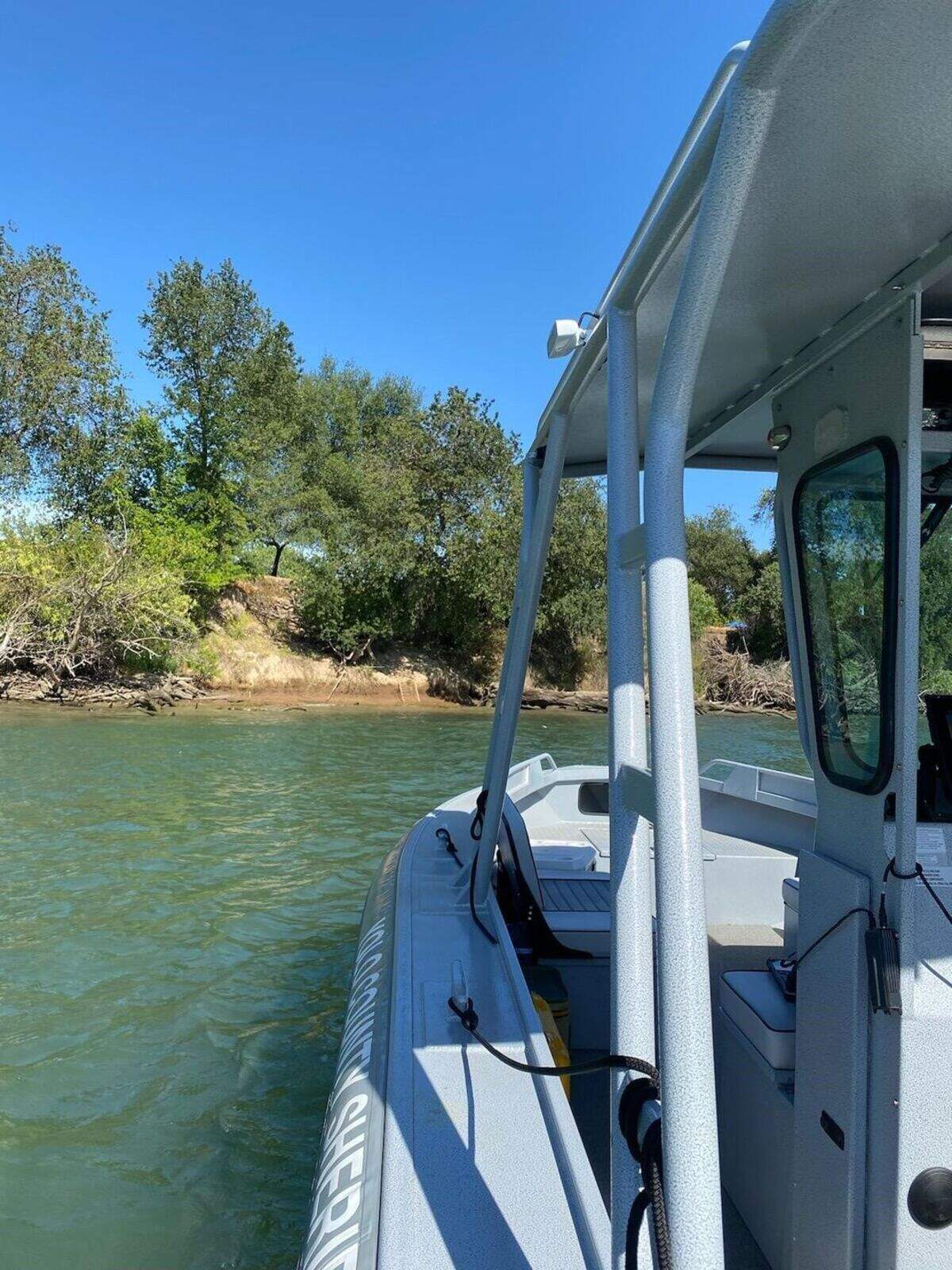 A Yolo County Sheriff’s Office search boat floats in the Sacramento River. Deputies are searching for 18-year-old Ahmir Watson, who disappeared in the river on July 28, 2021 while attempting to help a child in distress,