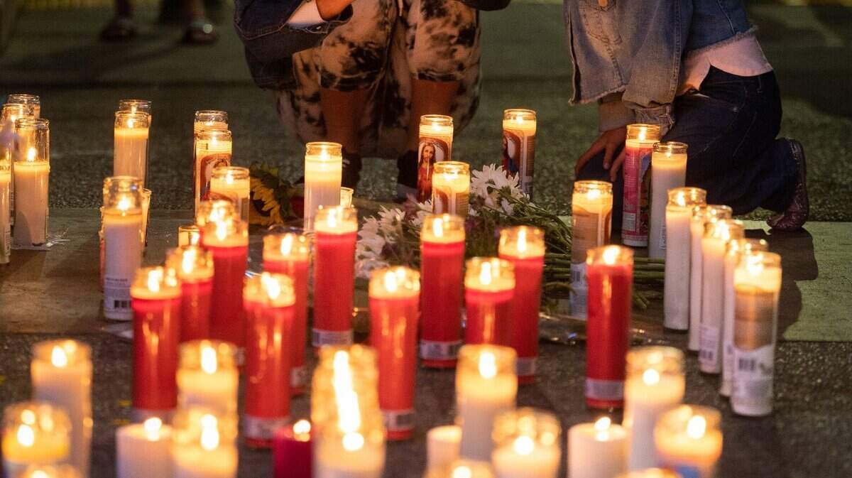 Sergio Harriss sister Eiexux Harris and niece Calista Smith light candles at a memorial in Sacramento, Monday, April 4, 2022, for Sergio, who was killed during Sunday mornings mass shooting at 10th and K Streets. The mass shooting left six people dead and 12 injured.