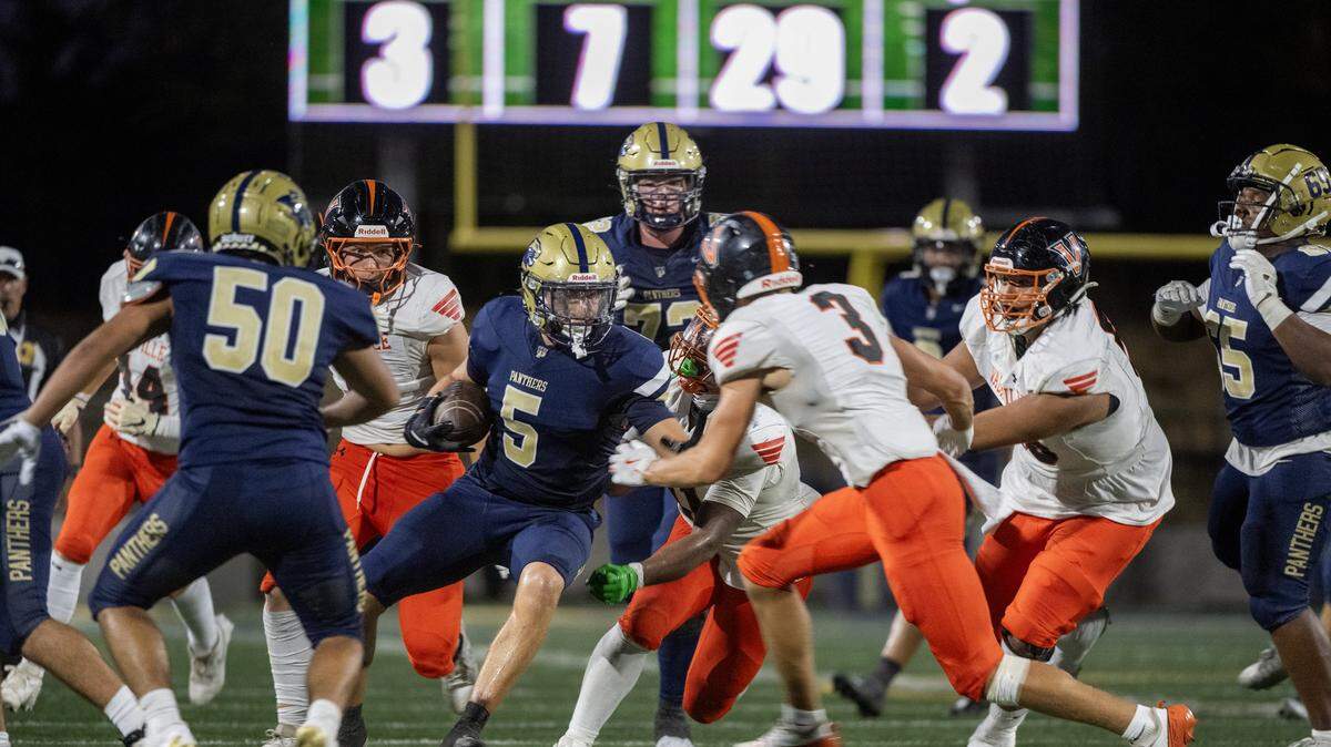 The West Park Panthers ’ Topher Petersen (5) cuts back against the Vacaville Bulldogs defense In the first half Friday in Roseville.