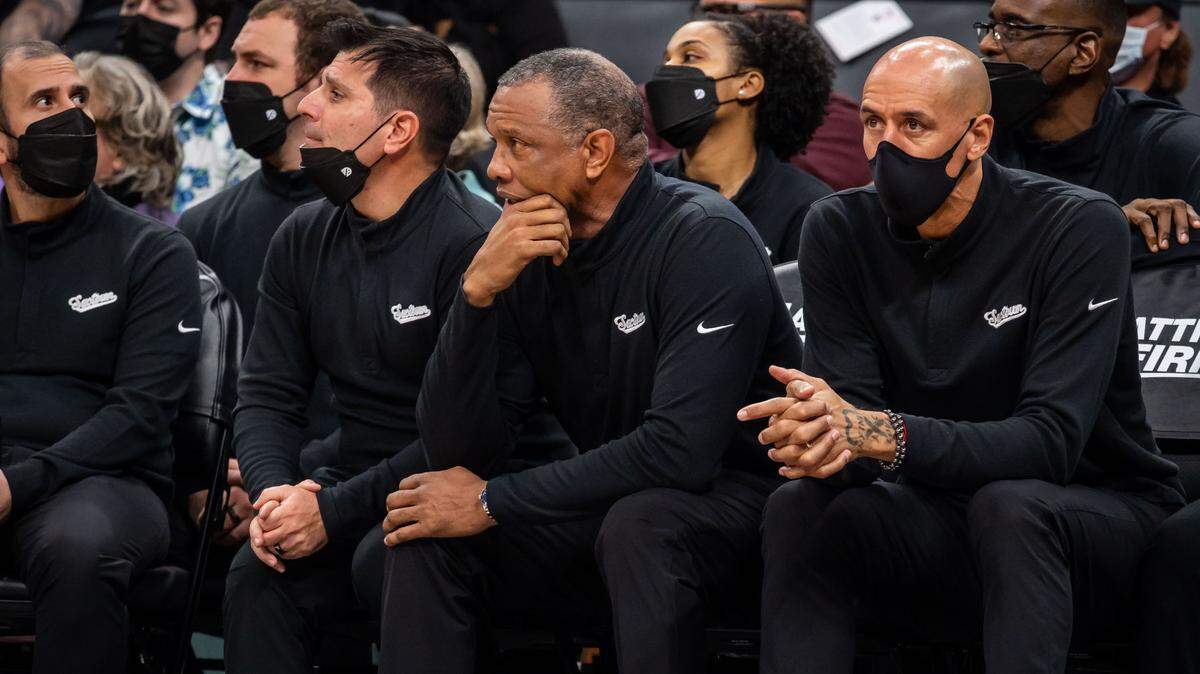 Sacramento Kings interim head coach Alvin Gentry, center, is flanked by assistance coaches Mike Longabardi, left, and Doug Christie as they watch the game against the Orlando Magic during the second half of the NBA basketball game Wednesday, Dec. 8, 2021, at Golden 1 Center in Sacramento. The Kings beat the Magic 142-130.