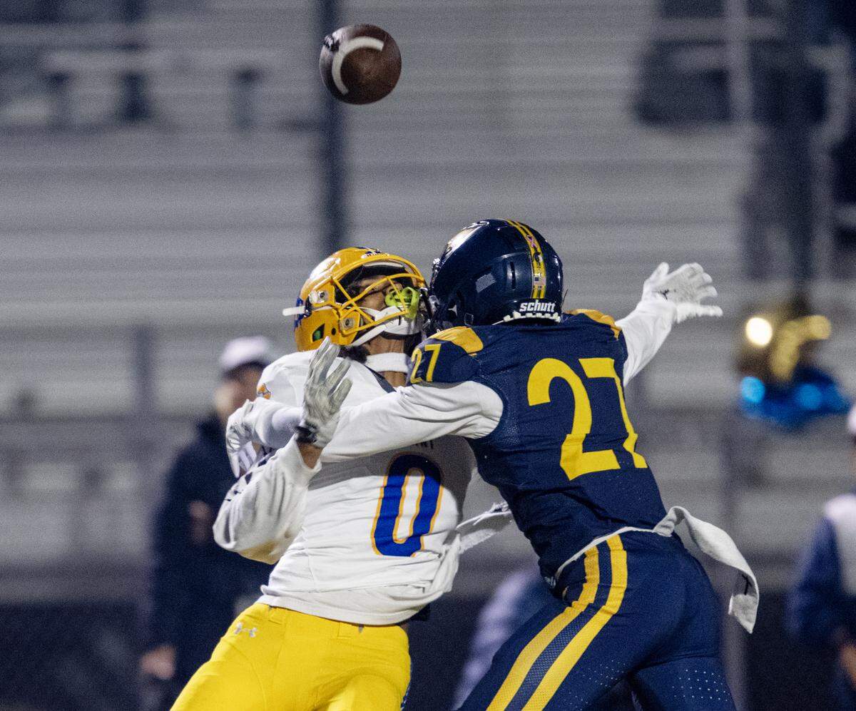 The Grant Pacers' Zo Edwards (0) is unable to bring in a pass as the Oak Ridge Trojans’ Jonathan Grosfeld defends in the first half in the CIF Sac-Joaquin Section Division l semifinal football playoff game in El Dorado Hills on Friday, Nov. 21, 2025.