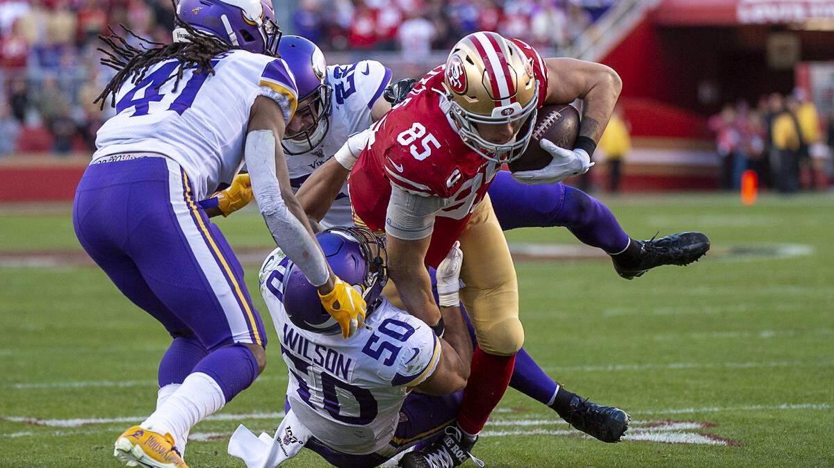 San Francisco 49ers tight end George Kittle (85) is tackled by Minnesota Vikings linebacker Eric Wilson (50) and Minnesota Vikings free safety Harrison Smith (22) in the fourth quarter during an NFC playoff game at the Levi’s Stadium on Saturday, Jan 11, 2020 in Santa Clara.