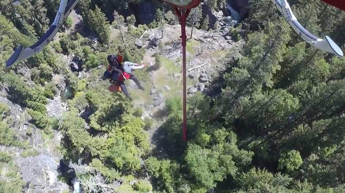 A rescuer from Sacramento Metropolitan Fire District’s Copter 2 hoists an injured kayaker near Heath Falls in the Tahoe National Forest on Saturday, June 1, 2024. The woman was treated for her injury at a hospital in Truckee, firefighters said.