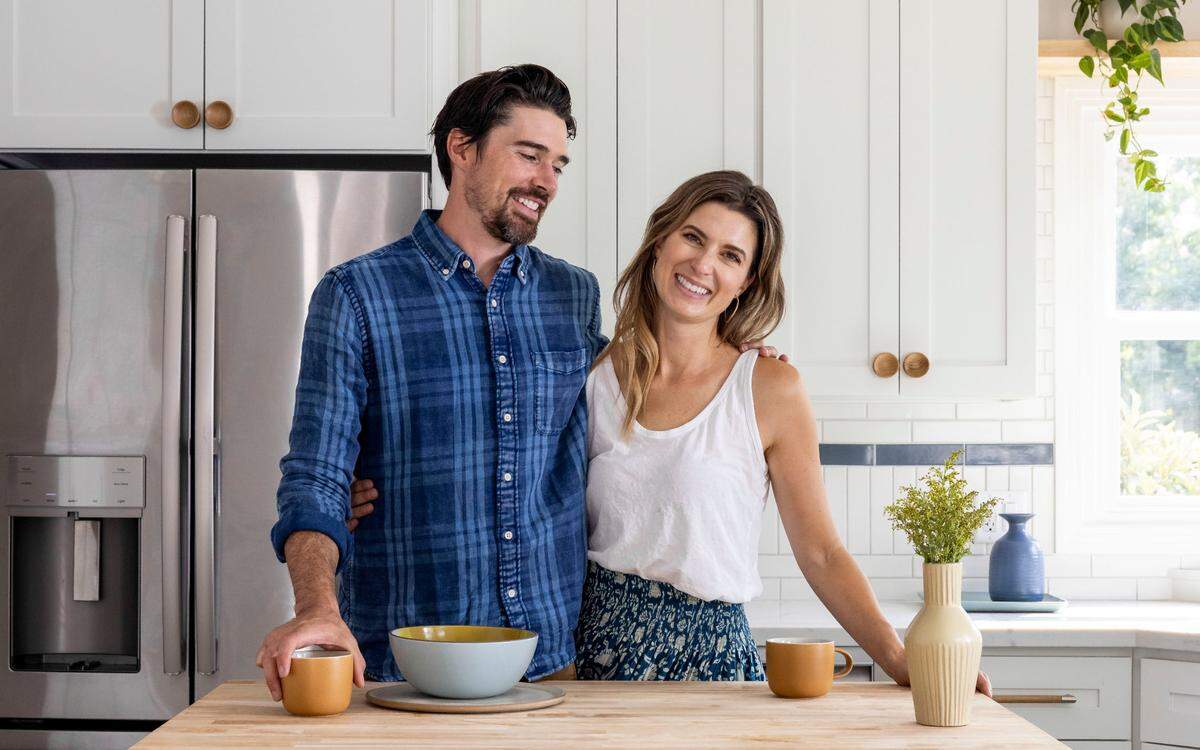 Kele Dobrinski and Christina Valencia stand in the kitchen of one of their Land Park bungalow renovations for the “Bright Harmony” episode of their HGTV show “Mash-Up Our Home.”