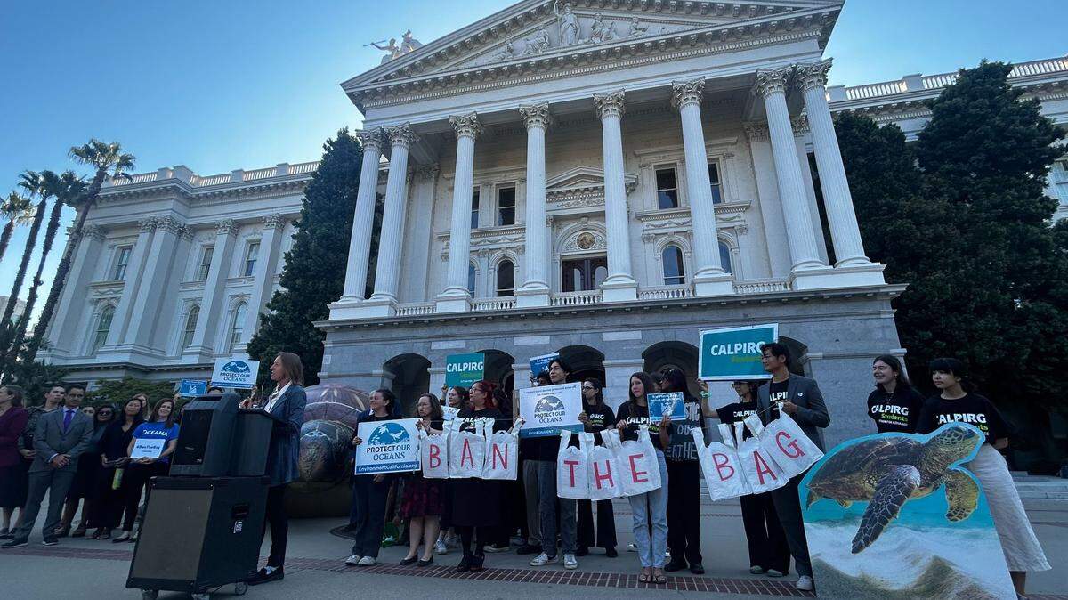 Supporters of a pair of California bills to ban retailers from offering reusable plastic bags gather in front of the Capitol in Sacramento.