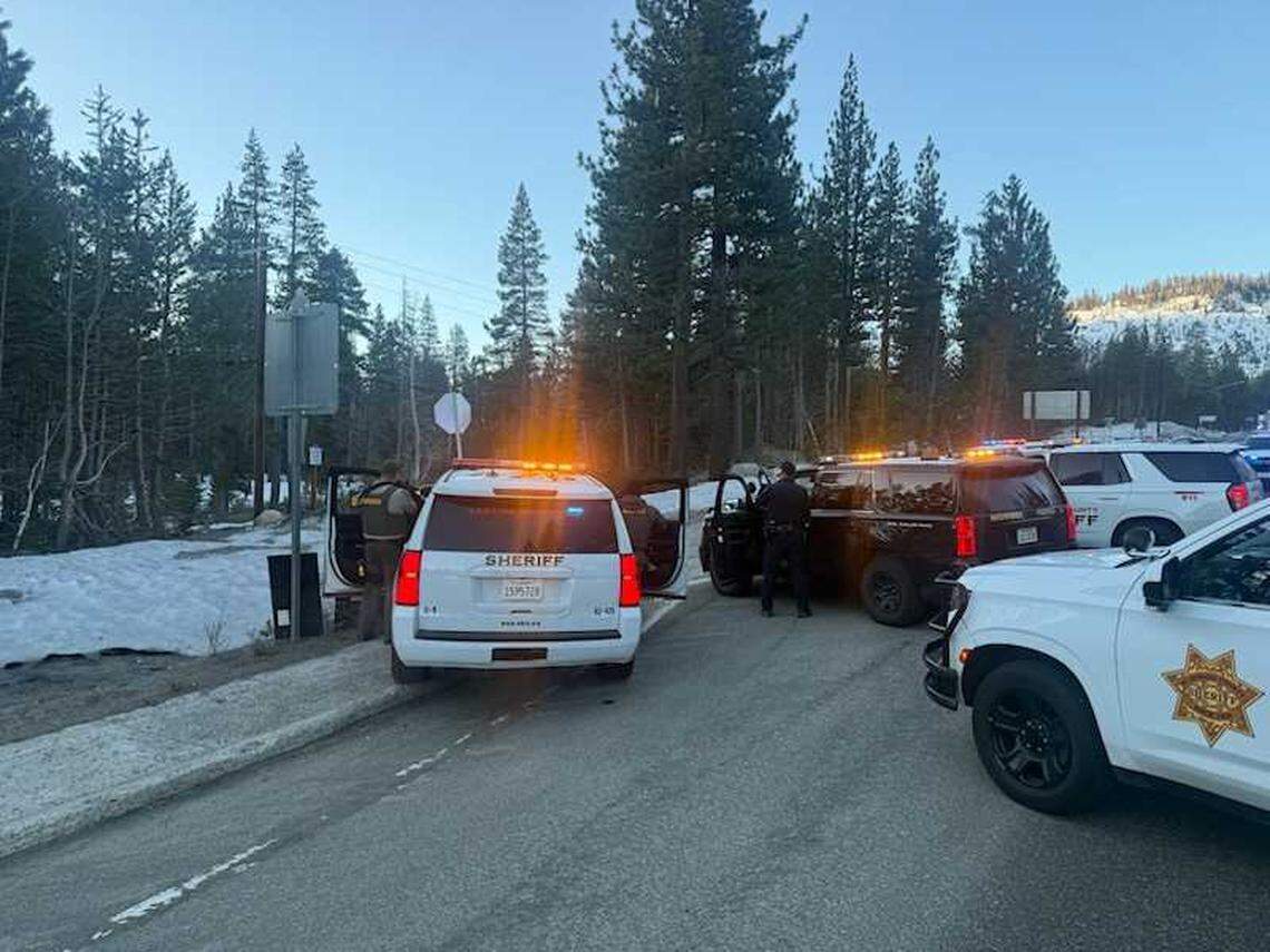 Law enforcement officers surround a white sedan during a felony stop on Highway 50 near South Upper Truckee Road west of Meyers, Calif., on Thursday, March 5, 2026. The driver was taken into custody around 8:45 a.m. after leading authorities on a four-hour pursuit that began in Rancho Cordova.