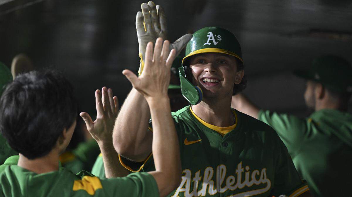 Athletics first base Nick Kurtz high fives his teammates after scoring a home run during a game against the Detroit Tigers at Sutter Health Park in Sacramento on Monday, Aug. 25.