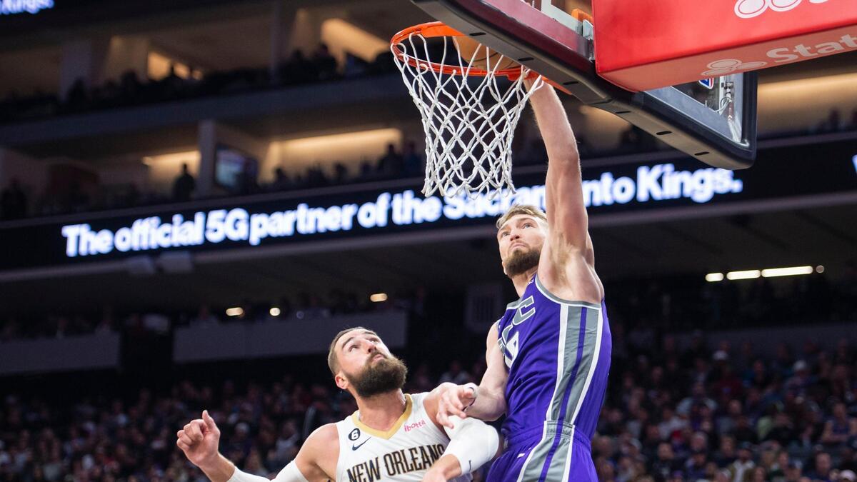 Sacramento Kings forward Domantas Sabonis (10) dunks on New Orleans Pelicans center Jonas Valanciunas (17) in the second half of the NBA basketball game Monday, March 6, 2023, at Golden 1 Center in Sacramento. Sabonis had a triple-double with 19 points, 11 rebounds and 11 assists. The Kings defeated the Pelicans 123-108.