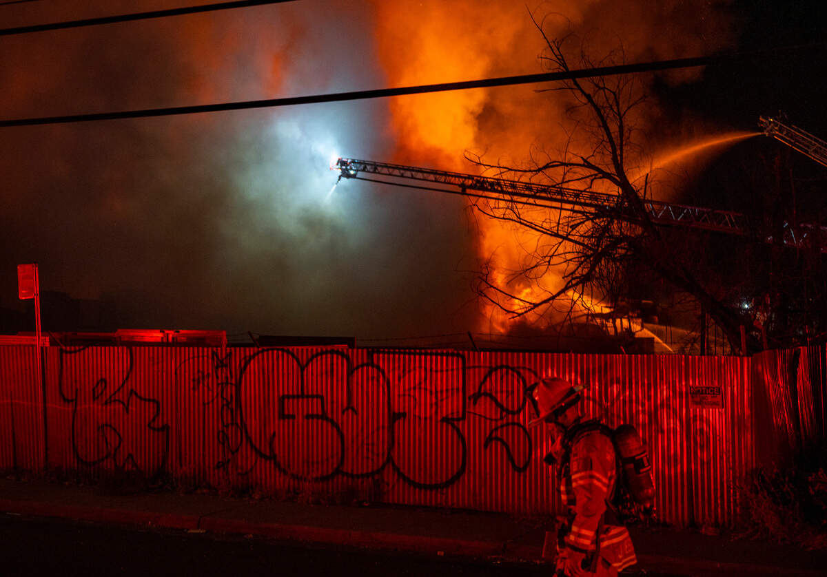 Firefighters battle a large pallet fire in an industrial section of Sacramento on Tuesday night, May 31, 2022.
