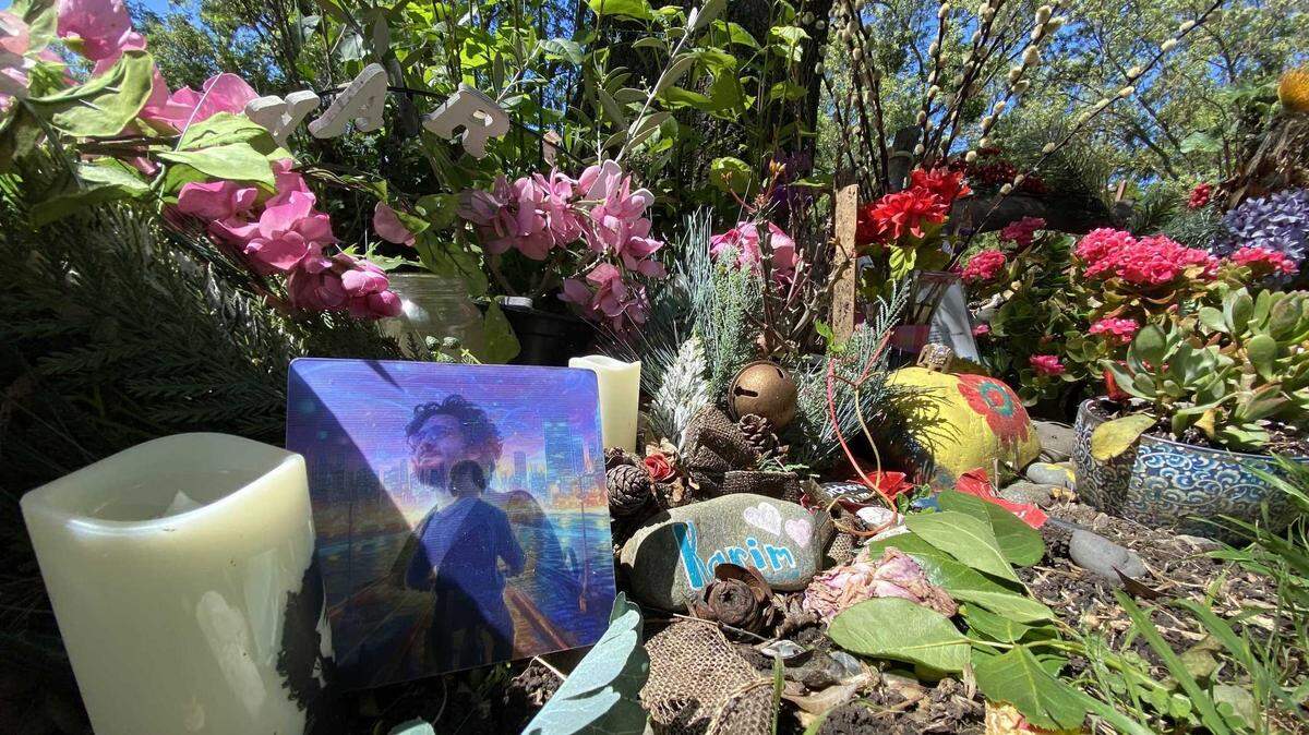 Fresh and wilted flowers adorned a memorial for Karim Abou Najm, at Sycamore Park on April 27, 2024. Najm was killed in April 2023 during a series of stabbings in Davis that rattled the city.