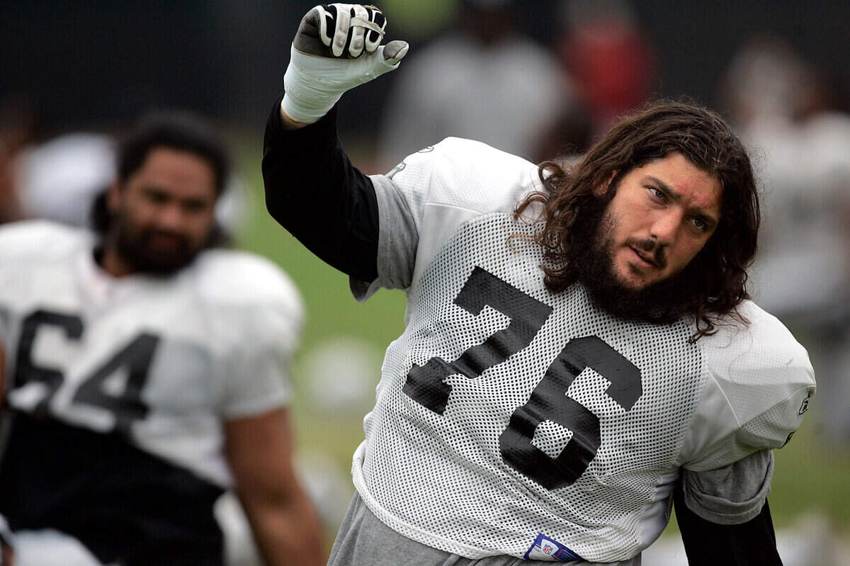 Oakland Raiders guard Robert Gallery stretches before morning practice during NFL football training camp in Napa, Calif., on Wednesday, Aug. 19, 2009.(AP Photo/The Press Democrat, Christopher Chung)