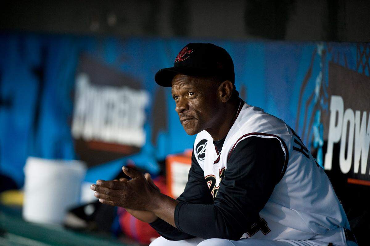Baseball Hall of Famer Rickey Henderson, working as a special instructor in the Oakland A’s organizations, watches the Sacramento River Cats from the dugout as they take on the Tacoma Rainiers in Game 1 of a 2010 playoff series at Raley Field in West Sacramento.