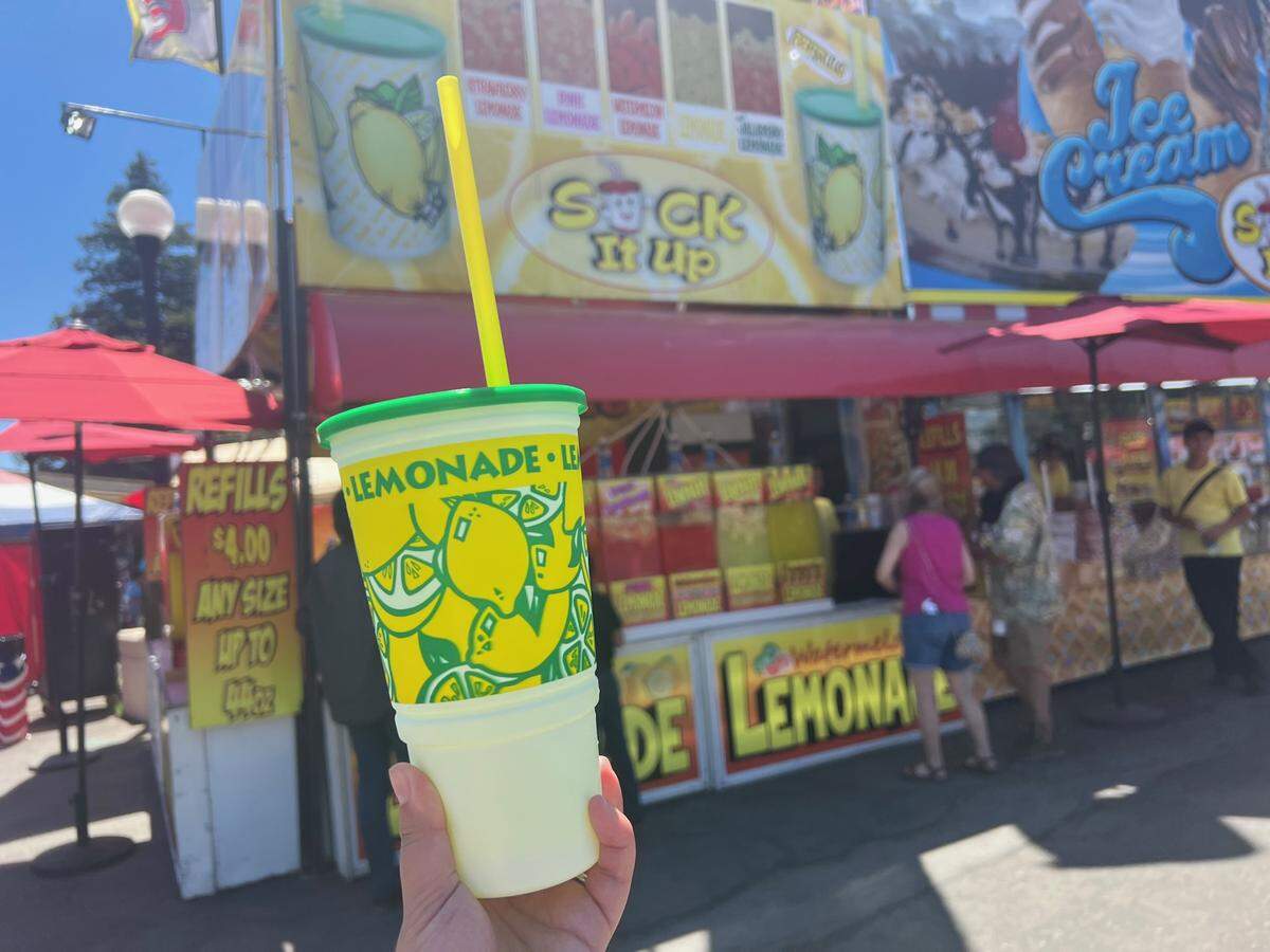 A Sac Bee reporter purchases a pineapple lemonade from a Suck It Up food stand at the State Fair.