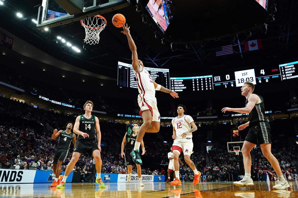 Darius Acuff Jr. (5) of the Arkansas Razorbacks lays up against Harry Rouhliadeff (14) of the Hawaii Rainbow Warriors during the first half in the first round of the 2026 NCAA Men’s Basketball Tournament at Moda Center on March 19, 2026 in Portland, Oregon.